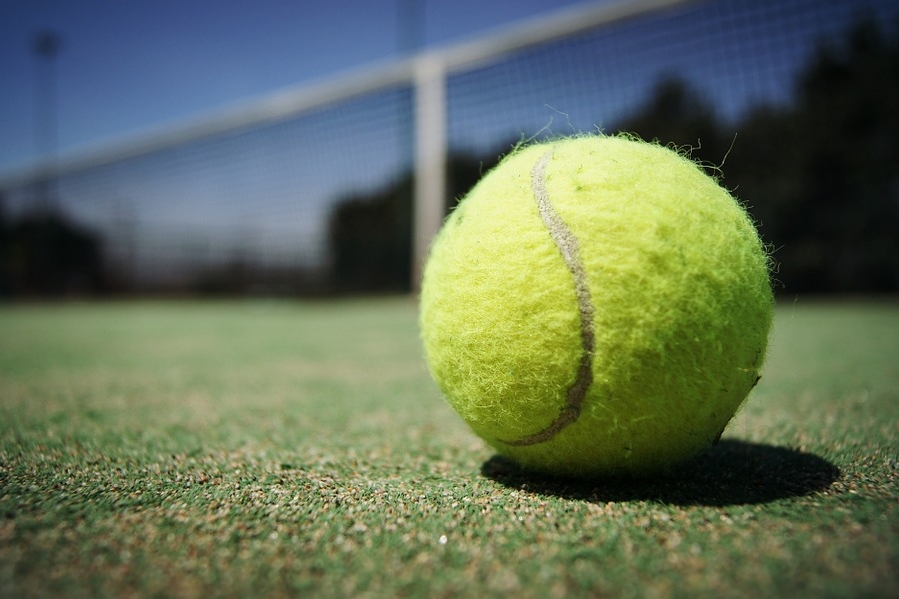 Surrey Tennis Centre - a close up of a ball on a grass court